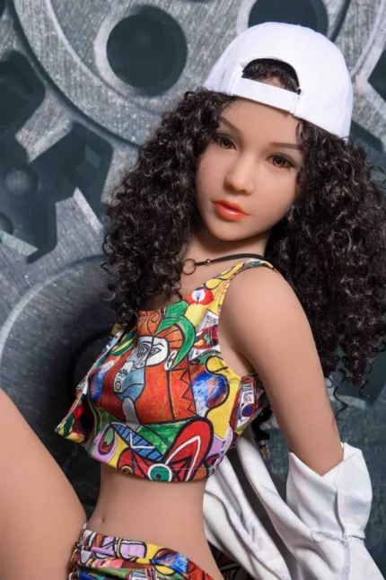 Petite real doll in elegant bedroom setting with realistic details